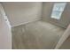 Clean bedroom with neutral carpeting, and a window for natural light at 265 Edinburgh Ln, Woodstock, GA 30188
