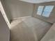 Bright bedroom with neutral walls and carpet, enhanced by the natural light from two windows at 265 Edinburgh Ln, Woodstock, GA 30188