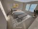 This staged bedroom features two windows, rug, bench, and modern decor at 265 Edinburgh Ln, Woodstock, GA 30188