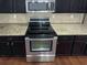 The kitchen features stainless steel appliances, granite counters, and dark cabinetry at 265 Edinburgh Ln, Woodstock, GA 30188