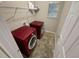 Functional laundry room equipped with red front-load washer and dryer, plus overhead shelving at 265 Edinburgh Ln, Woodstock, GA 30188