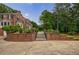 Brick steps leading to a tiered backyard with garden beds and mature trees at 280 Blackland Nw Rd, Atlanta, GA 30342