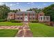 Elegant brick home with meticulously maintained lawn and stone pathway, enhancing its stately presence at 280 Blackland Nw Rd, Atlanta, GA 30342