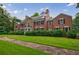 Elegant brick home boasts lush greenery, mature shrubbery, and traditional architectural details at 280 Blackland Nw Rd, Atlanta, GA 30342