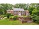 Beautiful brick home with a conservatory, landscaped steps, and mature manicured greenery at 280 Blackland Nw Rd, Atlanta, GA 30342
