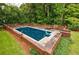 Private in-ground pool surrounded by brick coping, offering a serene and secluded retreat at 280 Blackland Nw Rd, Atlanta, GA 30342