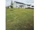 Lawn and tree in the backyard offer a peaceful view of the house, the neighborhood, and fence at 3378 English Elm Way, Loganville, GA 30052