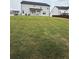 Large backyard with a well-maintained lawn, home, perimeter fence, and neighboring properties at 3378 English Elm Way, Loganville, GA 30052