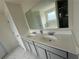 Bathroom featuring a double sink vanity, framed mirror and tub at 3378 English Elm Way, Loganville, GA 30052