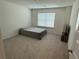 Cozy bedroom with neutral walls, plush carpeting, and a large window for natural light at 3378 English Elm Way, Loganville, GA 30052