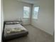 Cozy bedroom features carpet, two windows, and neutral colors at 3378 English Elm Way, Loganville, GA 30052