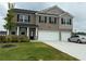 Two-story home with a brick facade, black shutters, and a well-maintained lawn with landscaped shrubs at 3378 English Elm Way, Loganville, GA 30052