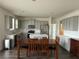 Open-concept kitchen featuring gray cabinets, stainless steel appliances, and a center island with dining table at 3378 English Elm Way, Loganville, GA 30052