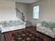 Bright living room with stairs features a staircase and hardwood floors at 3378 English Elm Way, Loganville, GA 30052