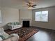 Bright living room features a fireplace, ceiling fan, and hardwood floors at 3378 English Elm Way, Loganville, GA 30052