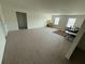 Open-concept living room with carpet features natural light from several windows at 3378 English Elm Way, Loganville, GA 30052