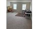 Spacious living room featuring plush carpeting, two windows and a unique display case at 3378 English Elm Way, Loganville, GA 30052