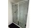 Bathroom shower showcasing marble tiling and a glass door at 3378 English Elm Way, Loganville, GA 30052