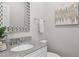 Elegant bathroom with a granite countertop, decorative mirror, and modern fixtures at 812 Dixie Ne Ave, Atlanta, GA 30307