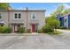 Two-story townhome featuring neutral siding, a red door, and manicured landscaping at 812 Dixie Ne Ave, Atlanta, GA 30307