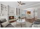 Open-concept living room featuring a fireplace, hardwood floors, and views of the kitchen and dining area at 812 Dixie Ne Ave, Atlanta, GA 30307