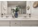 Bathroom featuring dual sinks with quartz countertops, decor, and a large mirror at 1209 Arnhem Dr, Hampton, GA 30228
