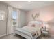 Cozy bedroom with a pink accent wall, white bed and stylish decor at 1209 Arnhem Dr, Hampton, GA 30228