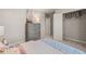 Neutral bedroom with an open closet and a gray dresser, offering storage at 1209 Arnhem Dr, Hampton, GA 30228