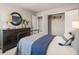 Bedroom showcasing a dark dresser and an open closet with a view through the doorways at 1209 Arnhem Dr, Hampton, GA 30228