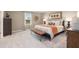 Bright bedroom featuring a large bed with stylish brown leather bench at the foot of the bed at 1209 Arnhem Dr, Hampton, GA 30228