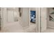 Hallway leading to a blue accent bedroom and other rooms, with neutral carpet at 1209 Arnhem Dr, Hampton, GA 30228