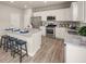 Modern kitchen featuring white cabinets, stainless steel appliances, granite countertops and a center island with seating at 1209 Arnhem Dr, Hampton, GA 30228