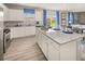 Well-lit kitchen with white cabinets, stainless steel appliances, granite countertops and center island at 1209 Arnhem Dr, Hampton, GA 30228