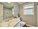 Bathroom offering a mirror, toilet, linoleum floor, and shower-tub combination with curtains at 2165 Shillings Chase Nw Dr, Kennesaw, GA 30152