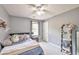 Comfortable bedroom with gray walls, carpeted floors, a ceiling fan and a large window at 2165 Shillings Chase Nw Dr, Kennesaw, GA 30152