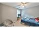 Cozy bedroom with gray walls, comfy seating, a bed, soft carpet, and a ceiling fan at 2165 Shillings Chase Nw Dr, Kennesaw, GA 30152