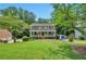 Inviting two-story home featuring a charming front porch and a lush green lawn, perfect for suburban living at 2165 Shillings Chase Nw Dr, Kennesaw, GA 30152