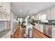 Bright kitchen showcasing stainless steel appliances, a center island with seating, and ample white cabinetry at 2165 Shillings Chase Nw Dr, Kennesaw, GA 30152