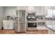 Updated kitchen with stainless steel appliances, modern backsplash, and ample counter space for cooking at 2165 Shillings Chase Nw Dr, Kennesaw, GA 30152