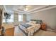 Spacious main bedroom features tray ceilings, built-in shelving, and large windows for lots of natural light at 2165 Shillings Chase Nw Dr, Kennesaw, GA 30152