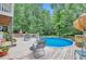 Backyard deck and above-ground pool with patio furniture surrounded by lush landscaping at 2165 Shillings Chase Nw Dr, Kennesaw, GA 30152