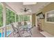 Screened porch with ceiling fan, outdoor furniture, and a view of the backyard at 2165 Shillings Chase Nw Dr, Kennesaw, GA 30152