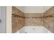 Stylish bathroom featuring a white tub with decorative tile surround at 262 Bell Grove Ln, Suwanee, GA 30024