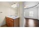 Bathroom vanity with double sinks, modern fixtures, and entry to bedroom at 262 Bell Grove Ln, Suwanee, GA 30024