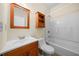 Standard bathroom with white tub, wood vanity and mirror at 262 Bell Grove Ln, Suwanee, GA 30024