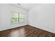 This bedroom features a window for natural light and wood-look flooring at 262 Bell Grove Ln, Suwanee, GA 30024