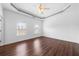 Bright bedroom featuring a trey ceiling, ceiling fan, and hardwood floors at 262 Bell Grove Ln, Suwanee, GA 30024