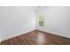This bedroom features a window for natural light and wood-look flooring at 262 Bell Grove Ln, Suwanee, GA 30024