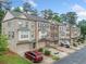 Beautiful brick townhomes featuring attached garages, neutral paint, manicured lawns, and professional landscaping at 262 Bell Grove Ln, Suwanee, GA 30024