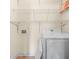 Laundry room with white wire shelving and white front load washer at 262 Bell Grove Ln, Suwanee, GA 30024